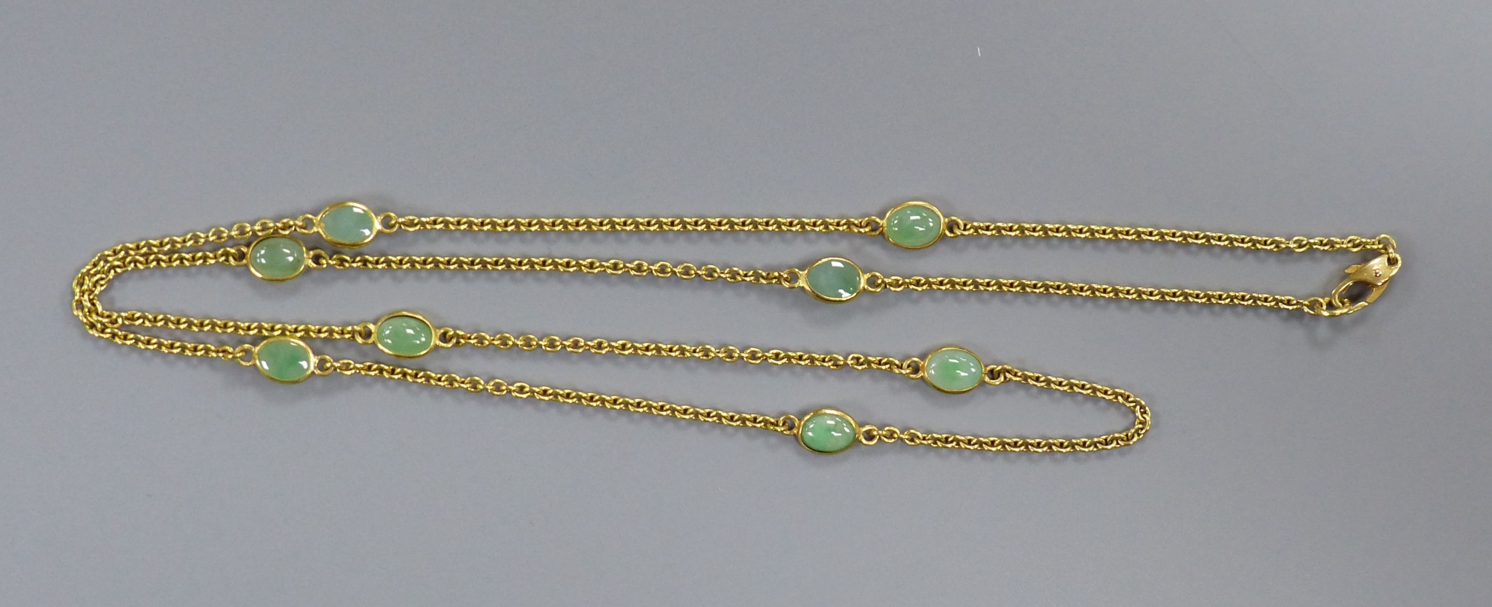 A modern 9ct gold and eight stone cabochon jade set 'spectacle' necklace, 60cm,